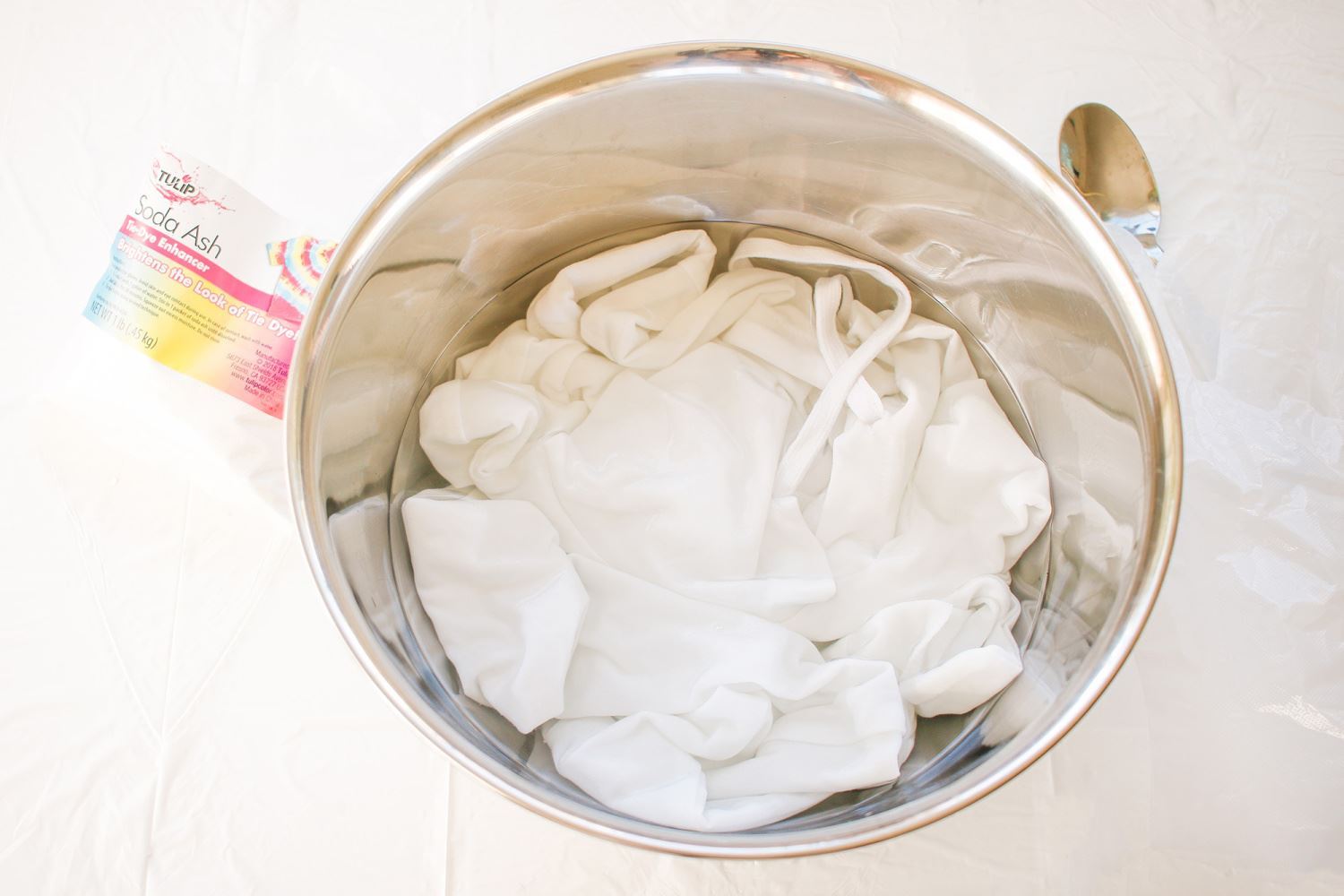 Can you use soda ash after tie dyeing during the first wash? WIll it help  if you didn't soak in soda ash pre-dyeing?