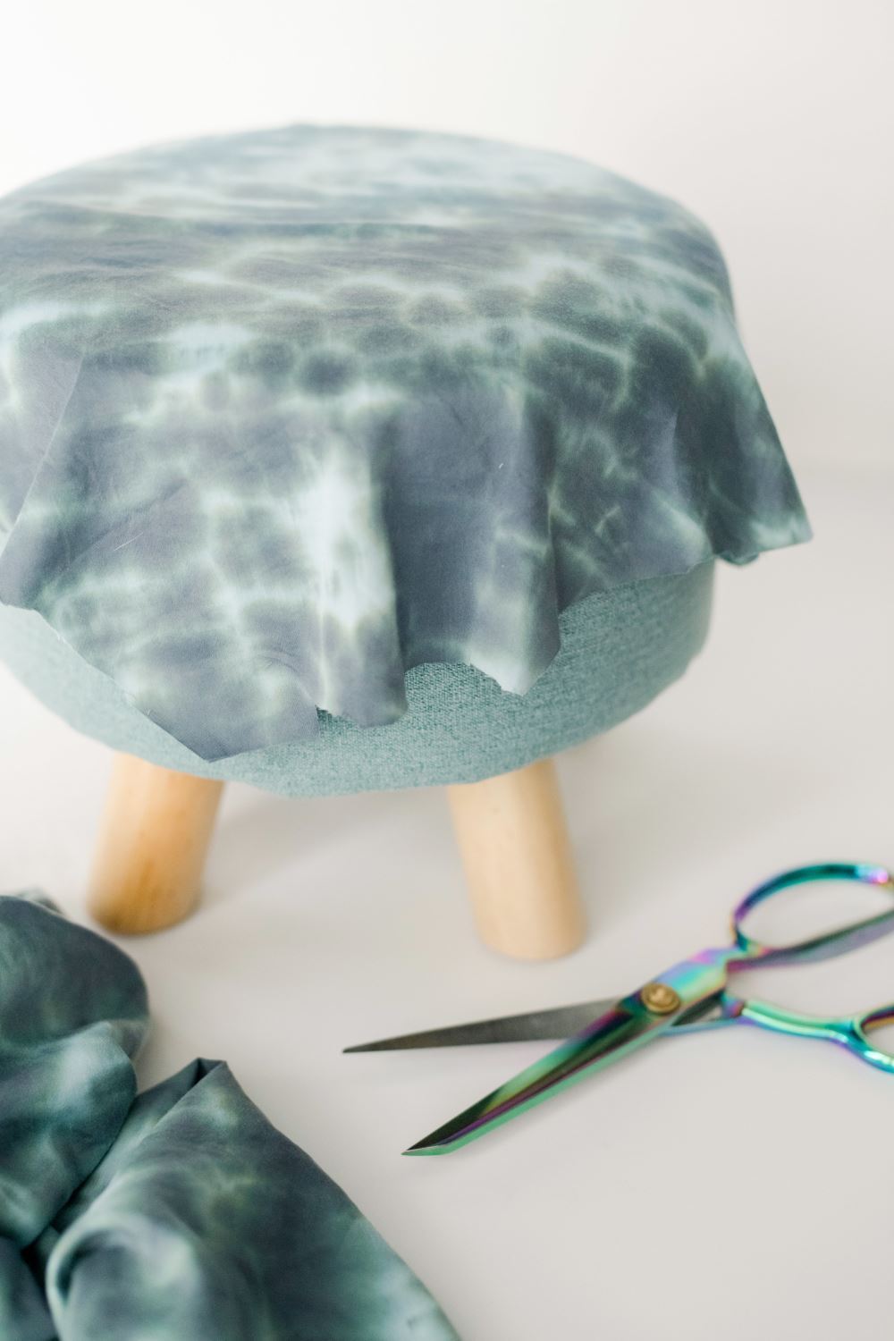 Wrap and glue fabric onto top of stool.